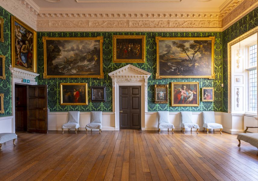 A wall of the picture gallery with frame paintings all over