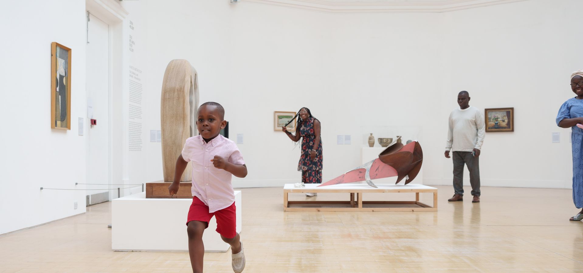 A child running towards the camera in a gallery