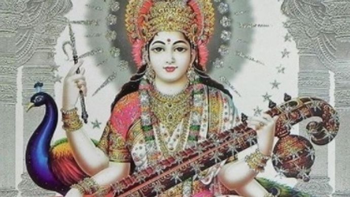 A person with 4 hands holding a guitar with crossed legs
