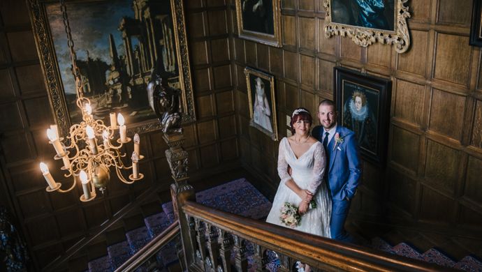 A wedding couple on the oak staircase of Temple Newsam