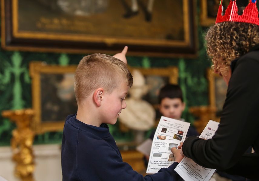 A child looking at a handout sheet with an adult