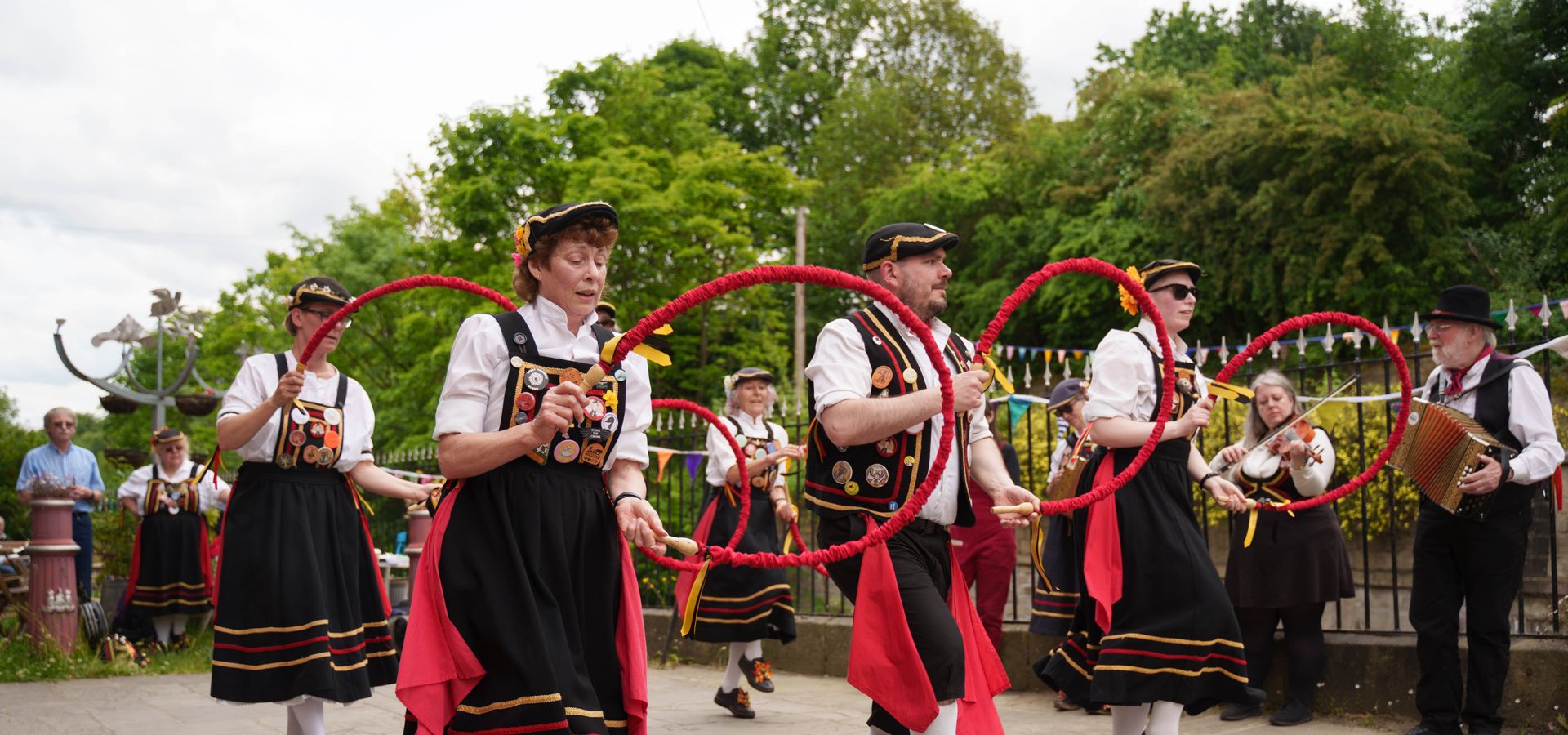 A group of line dancers in an ourdoor space