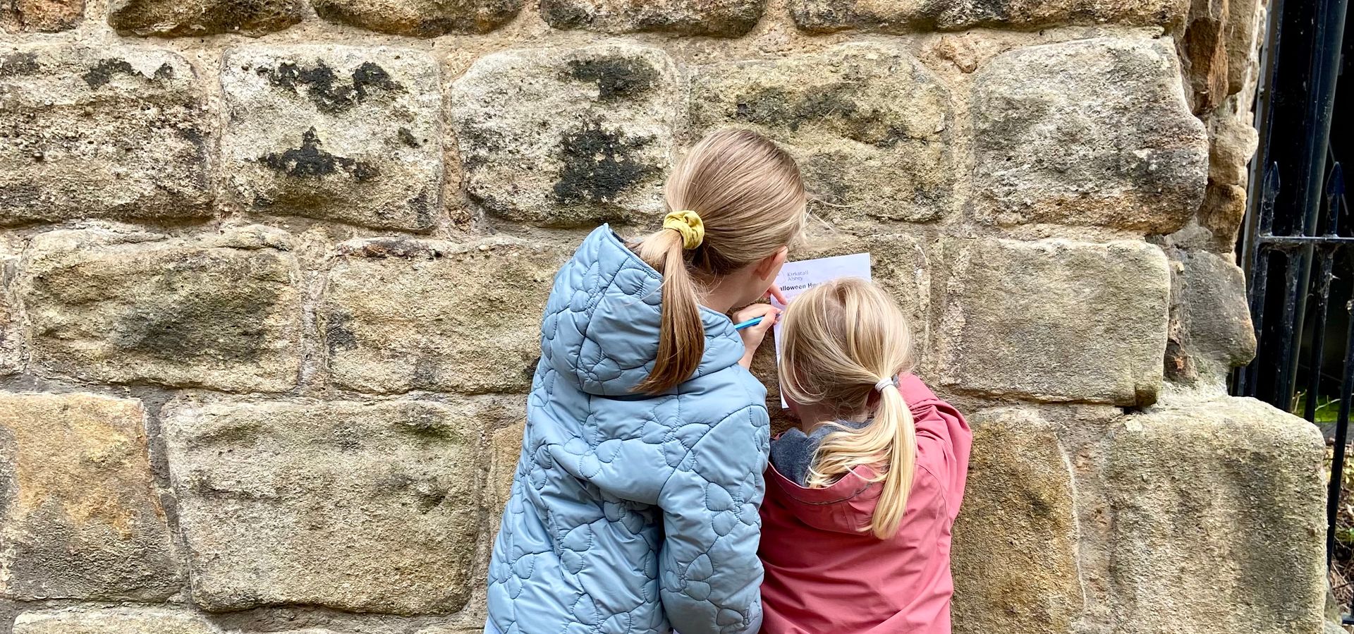 Two children completing a trail in Kirkstall abbey