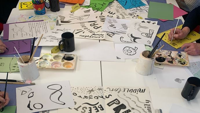 A table will illustrations and craft materials on