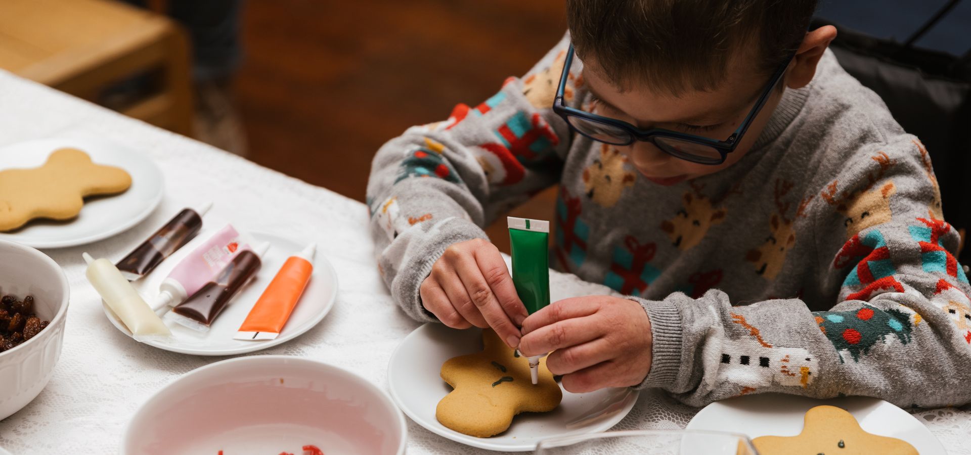 A child decorating ginger bread cookies