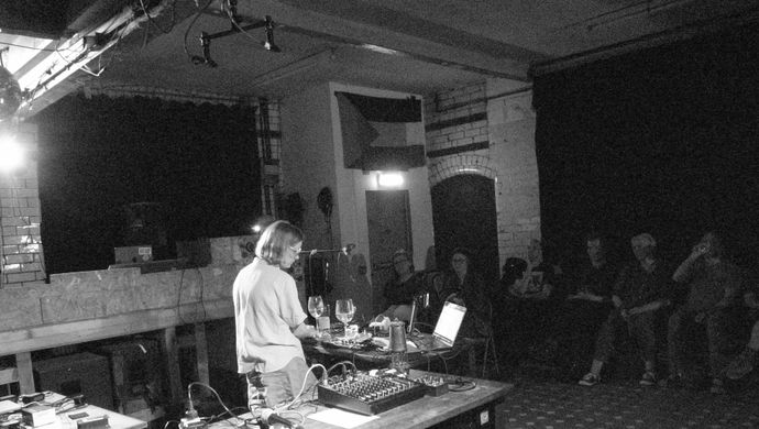 Mia Windsor using found objects as musical instruments.