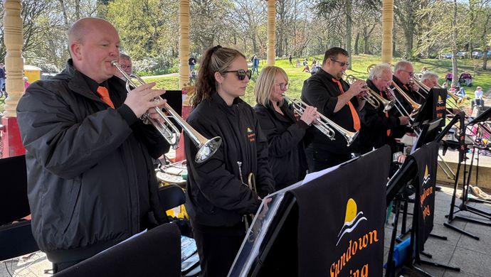 A brass band called the sundown swing playing in a tent