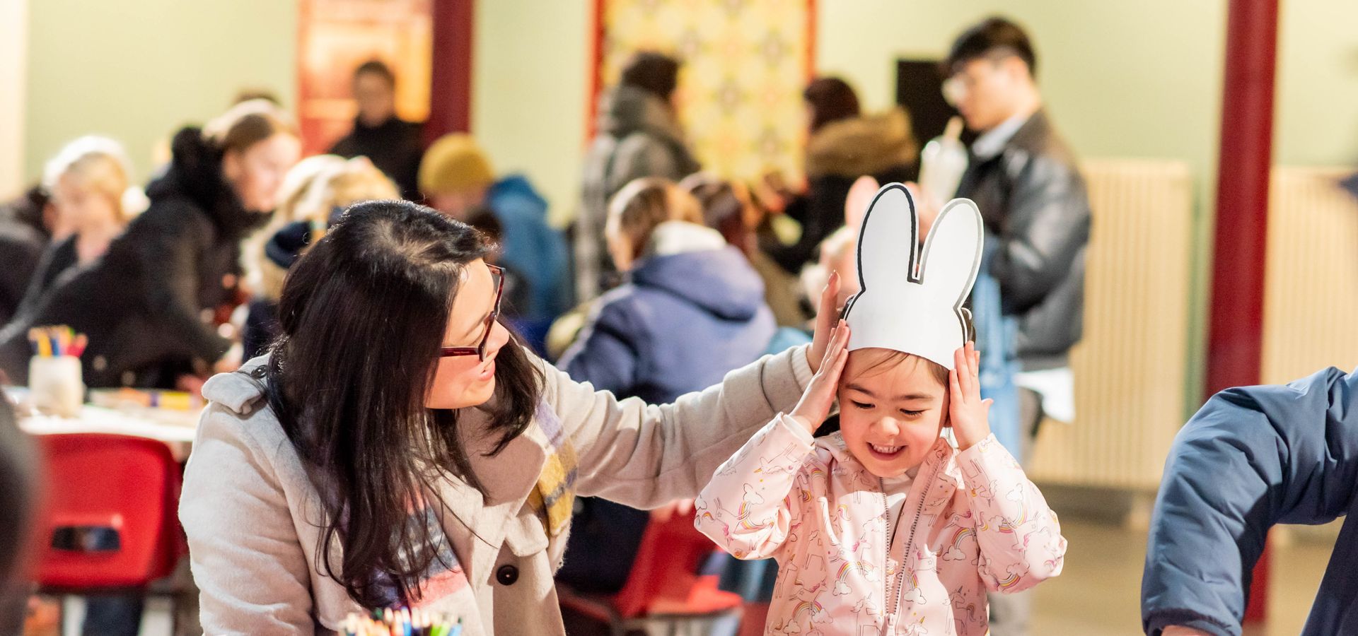 A young girl and parent doing crafts at Leeds City Museum