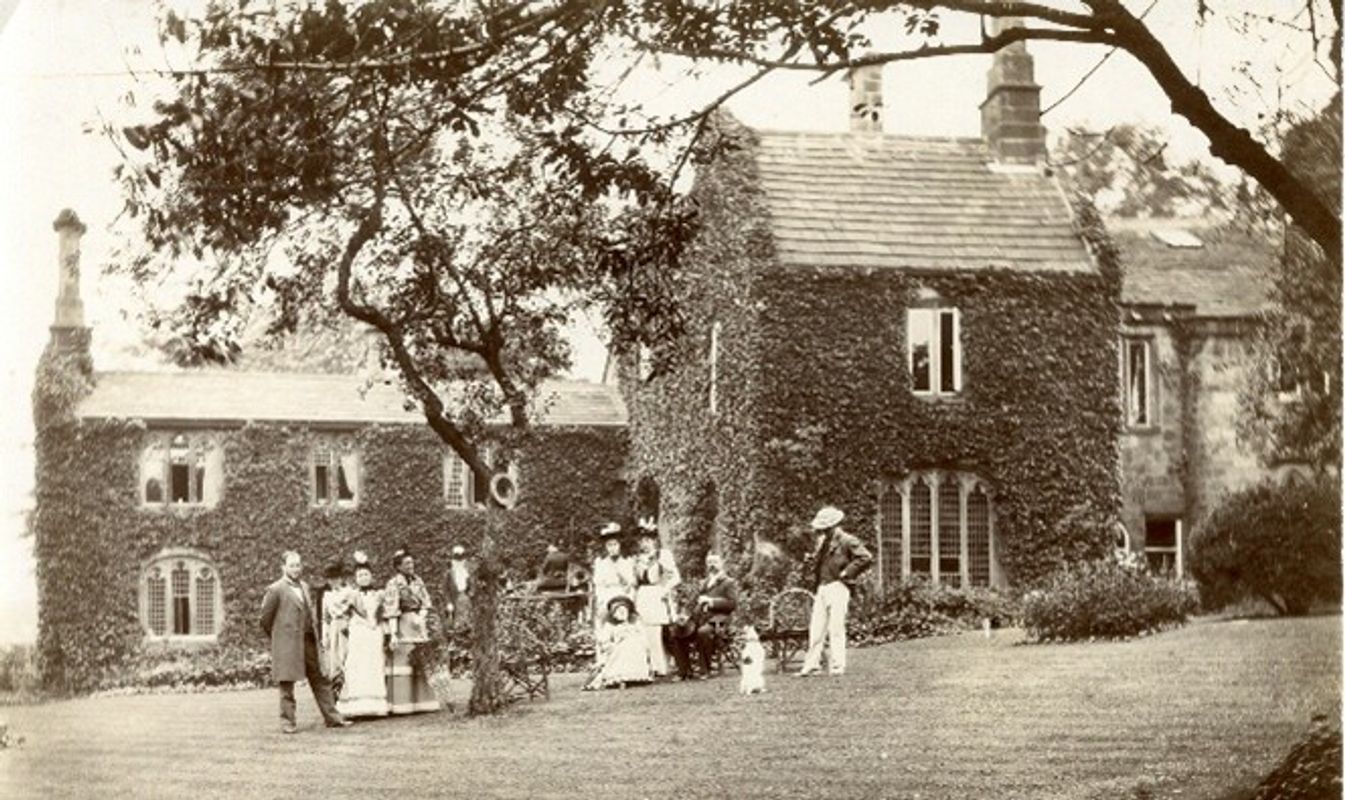 A black and white image of a family stood in front of Abbey House Museum in around 1900