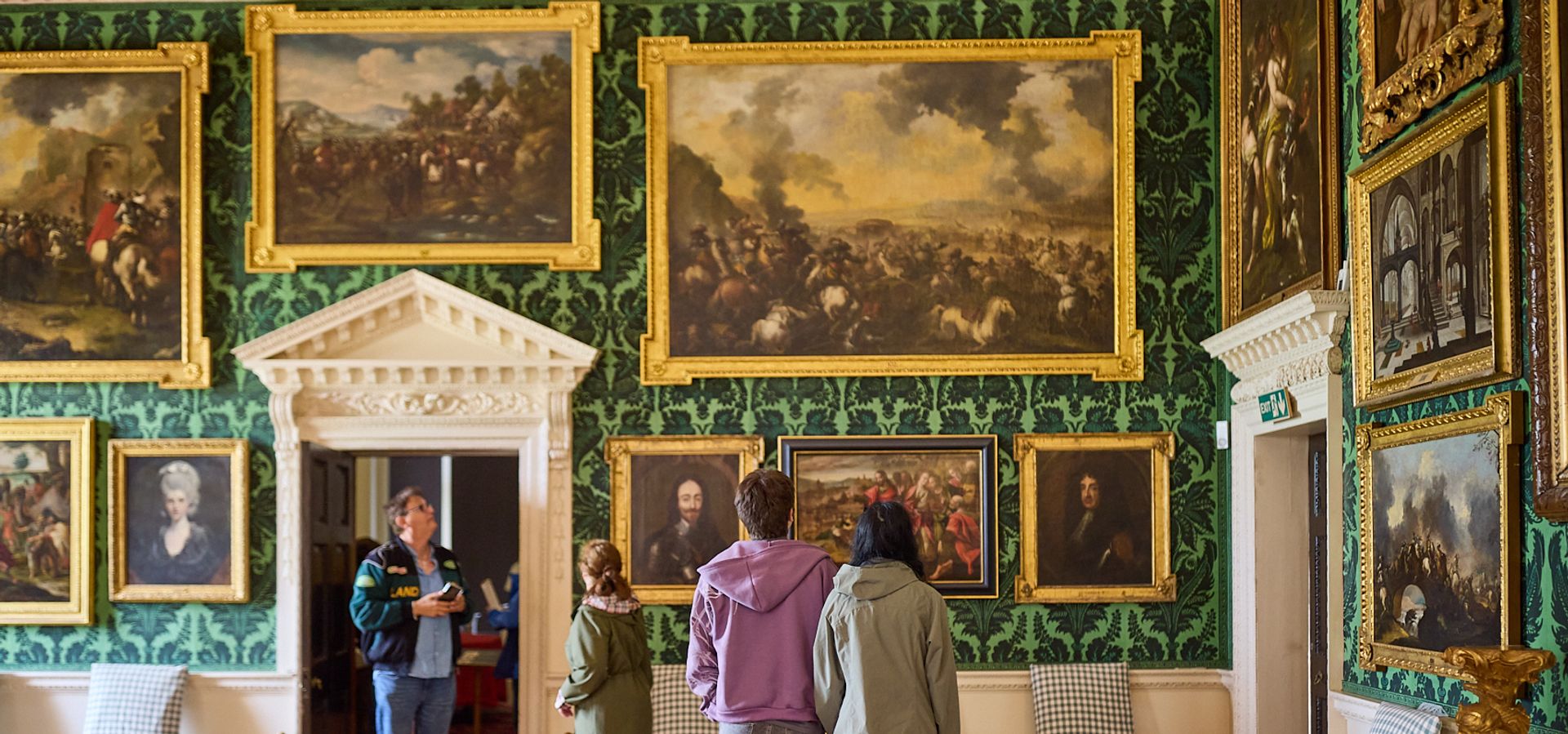 A group of people looking at a wall in the Picture Gallery at Temple Newsam