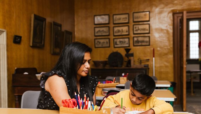 A parent and child drawing in the craft room in Temple Newsam House
