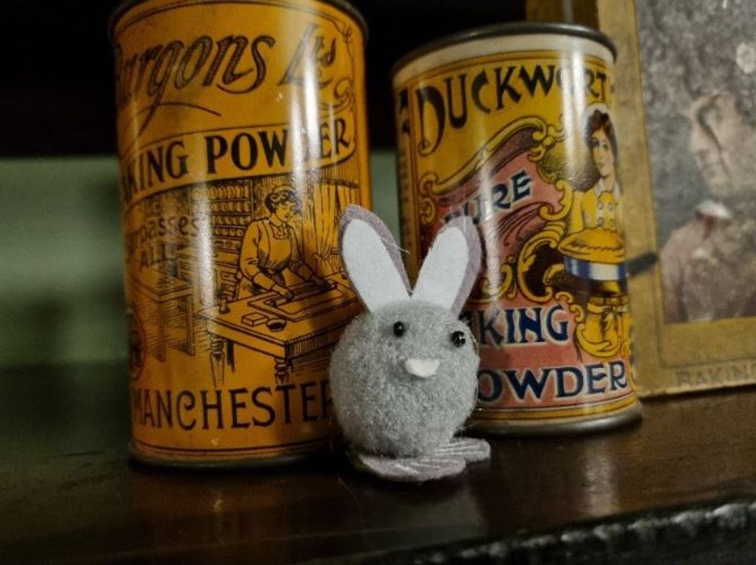 A felt bunny hidden amongst some pots at Abbey House Museum
