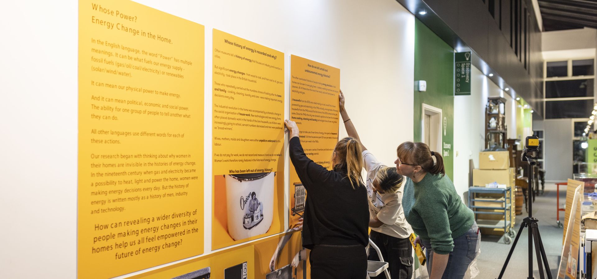 members hanging yellow interpretation boards