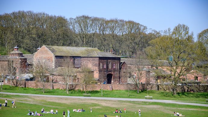Image of Temple Newsam Home Farm and people sat on the grass infront