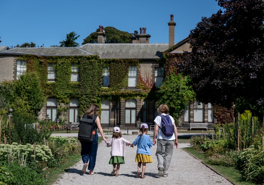 two children and two adults walking up to Lotherton House