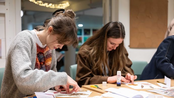 two people doing plant crafts at a table