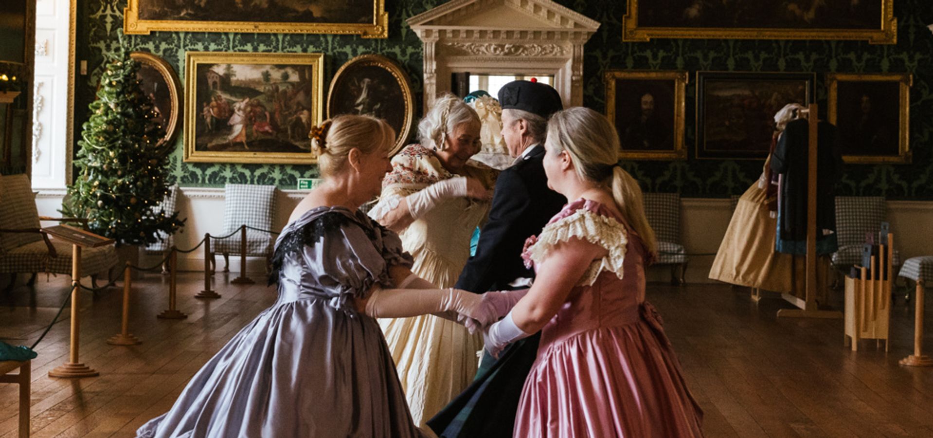 A group of dancers in long dresses