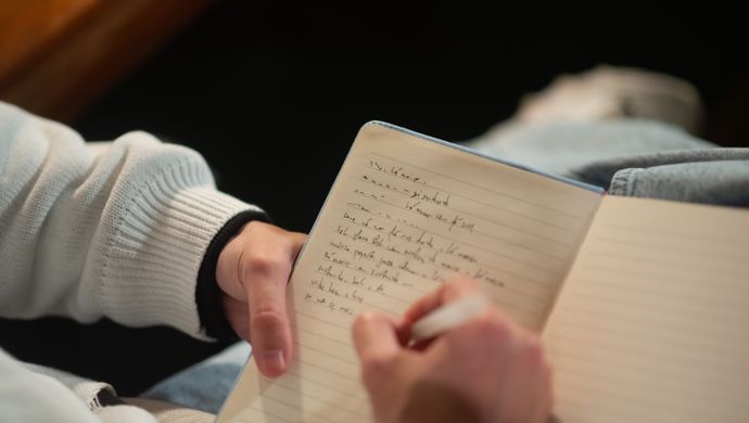 A person writing in a notebook