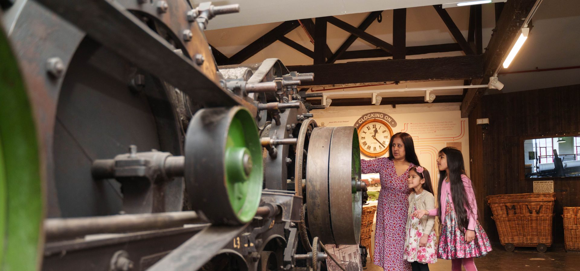 Mother and two daughters looking at industrial heritage