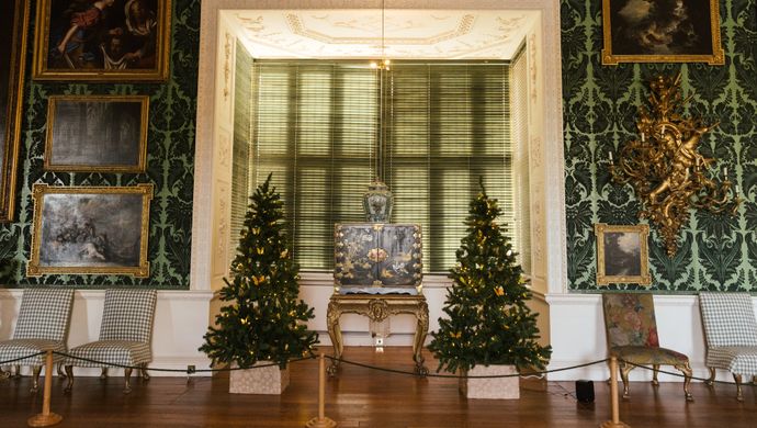 Two Christmas trees in the bay window of The Picture Gallery at Temple Newsam