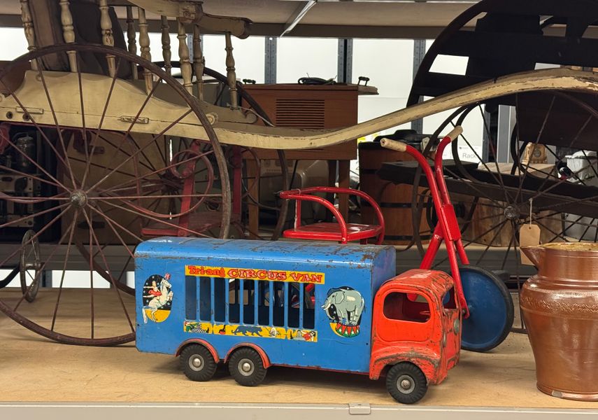 An old toy truck with items behind it from the Leeds Museums and Galleries social history collection
