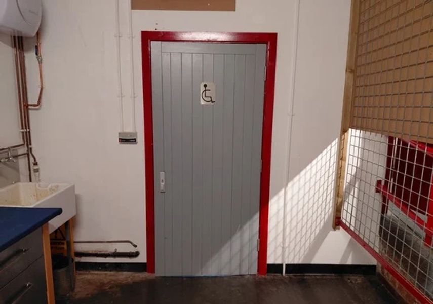 Photograph of grey toilet door