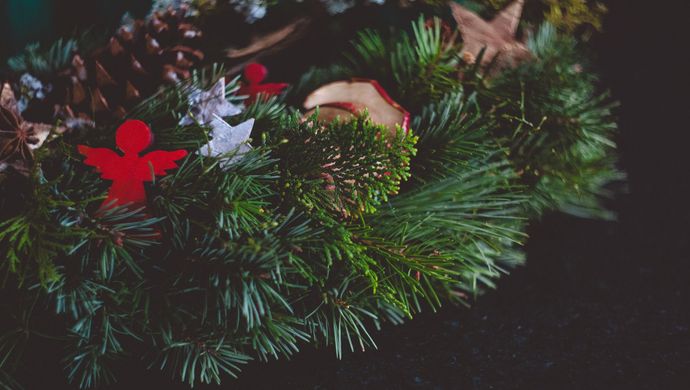 Green wreath with small decorated items placed on top