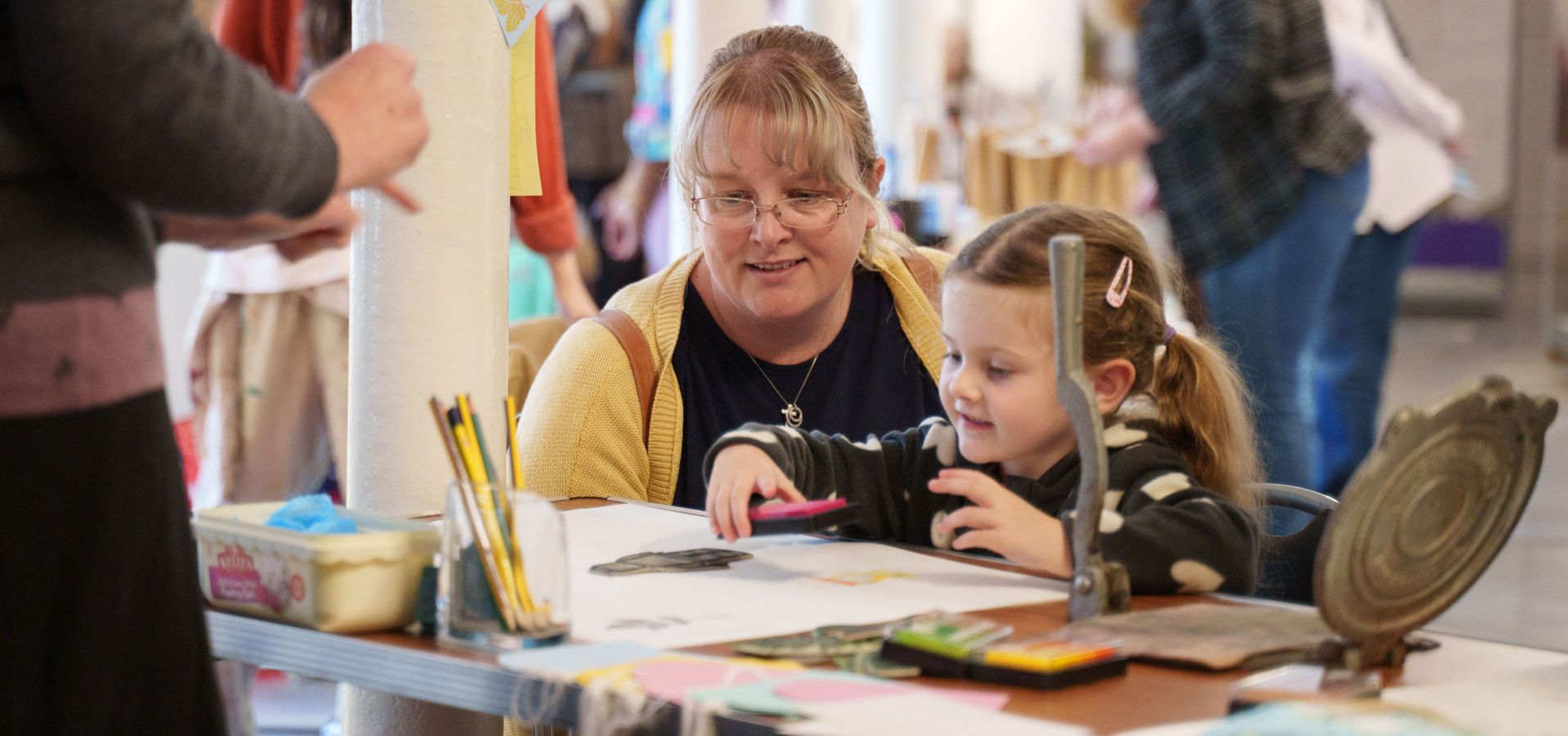 A mum and child doing printing