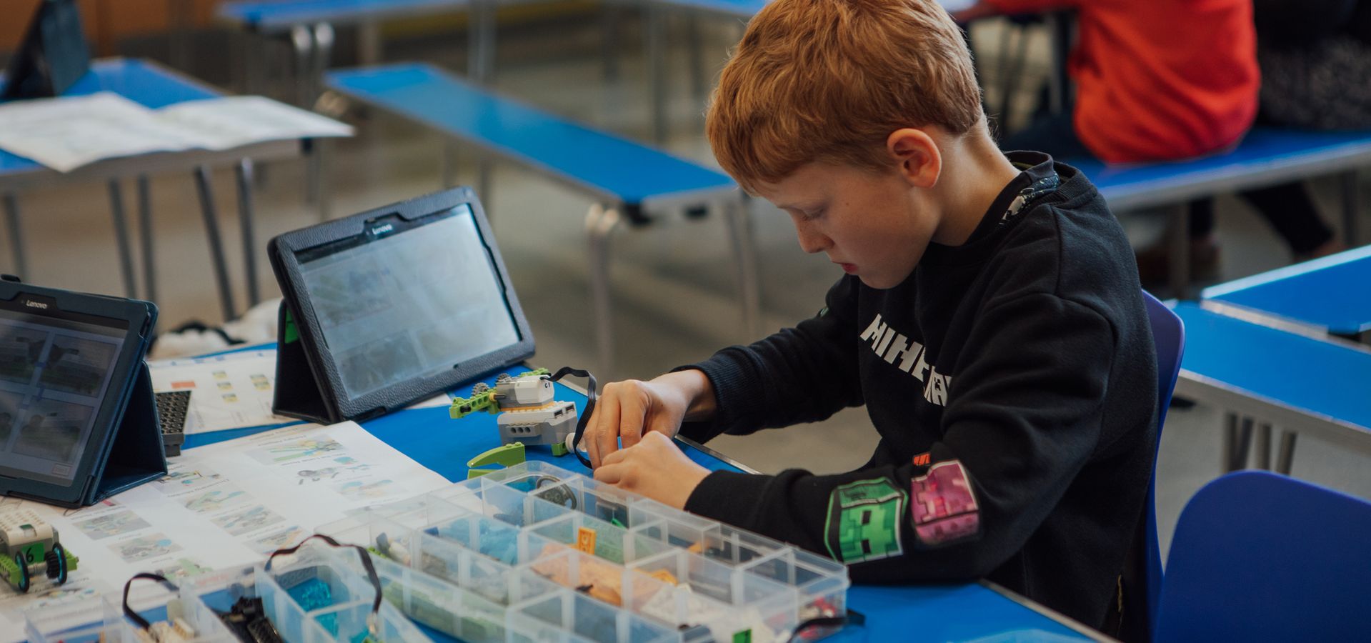 A boy doing crafts at a table