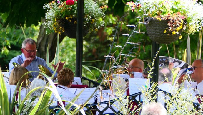 Summer band playing in the outdoors surrounded by flowers