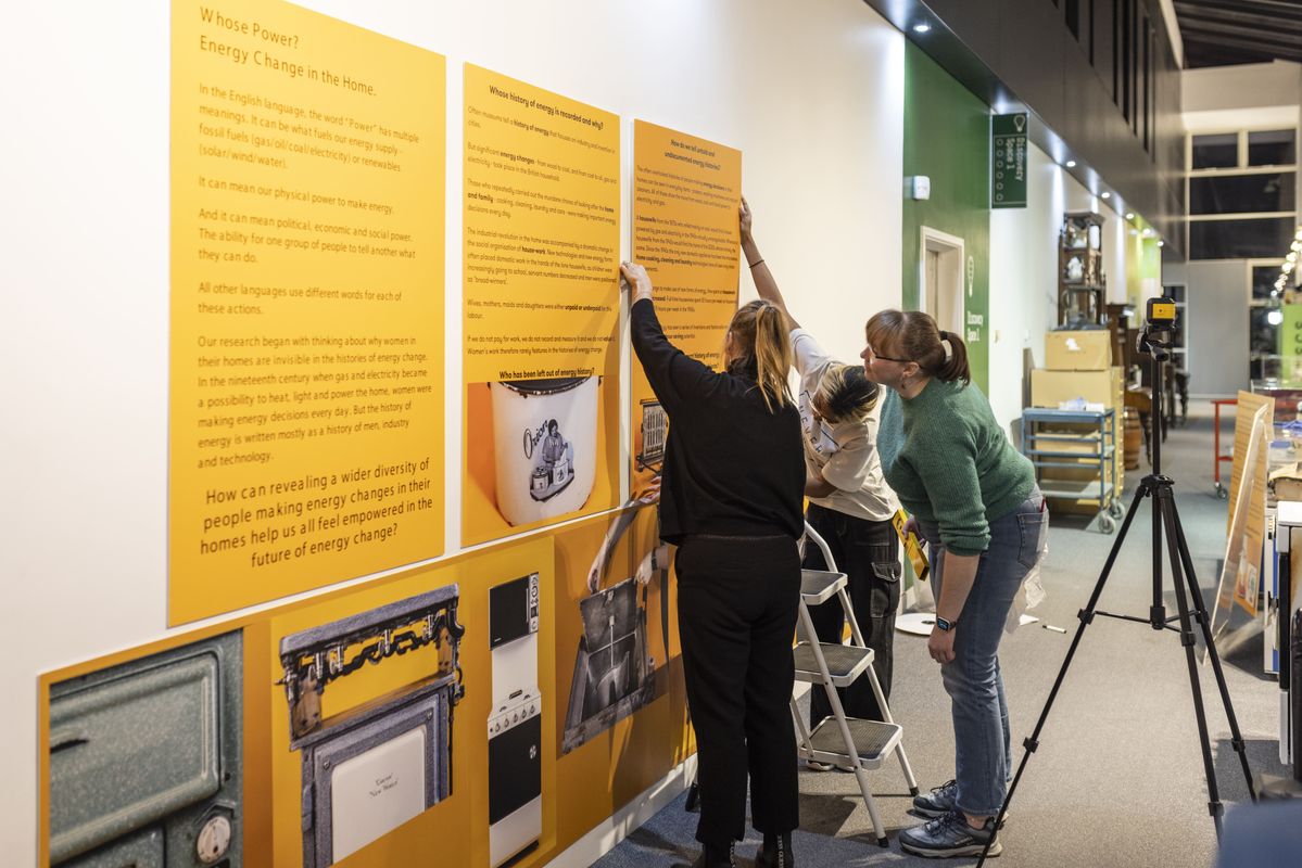 members hanging yellow interpretation boards
