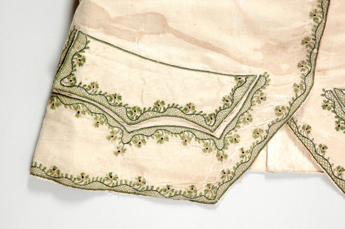 Waistcoat, 1760s made of a cream, ridged silk, possibly a Paduasoy, decorated with a hand embroidered design of flowers and leaves.   