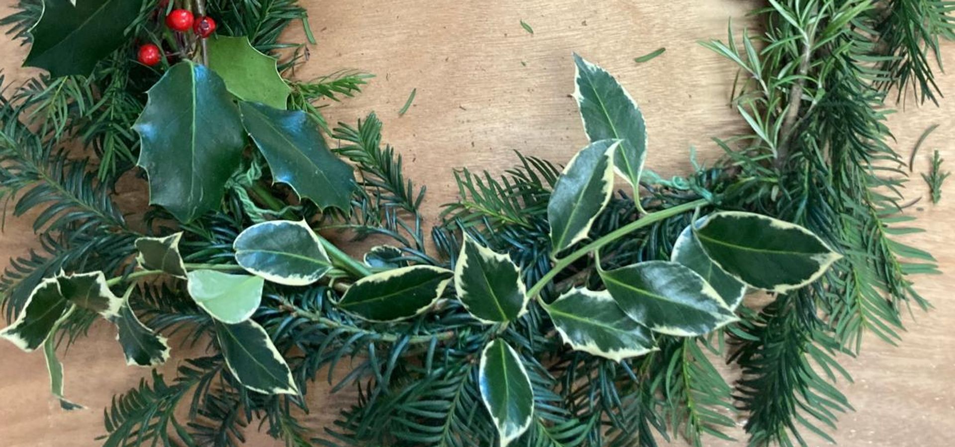 A foraged wreath with holly and fur