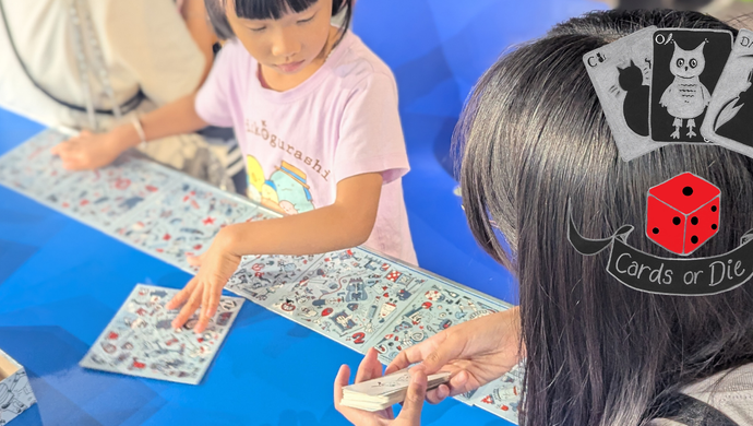Family playing board games with an overlayed Card or Die logo