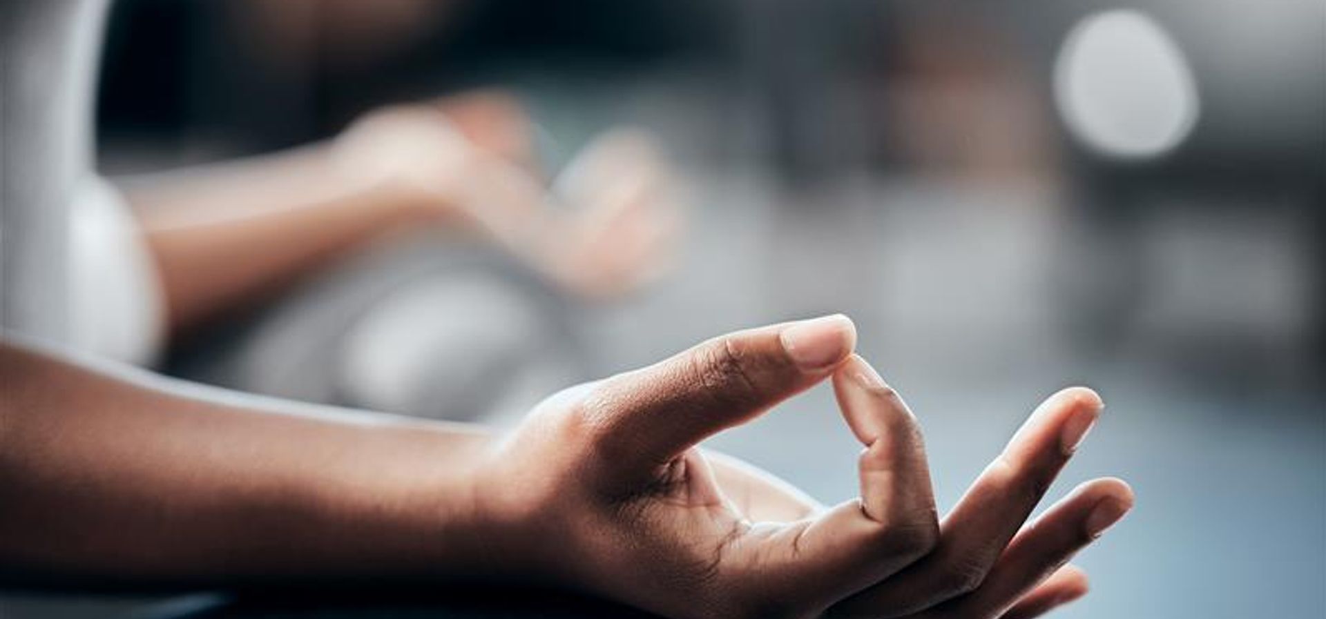 A hand on their knee to meditate