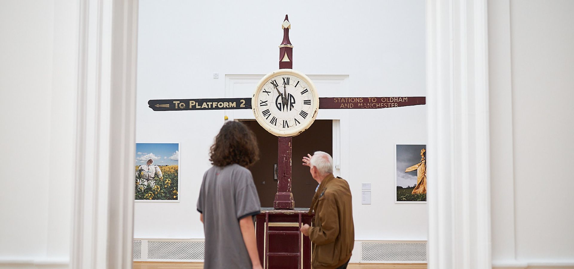 Two adults looking at a clockwork sculpture