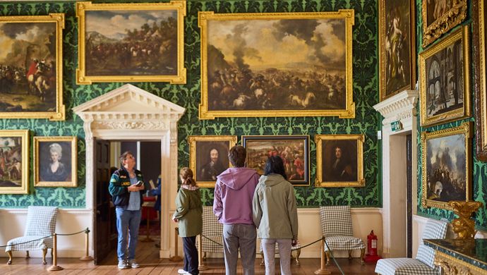 A group of people looking at a wall in the Picture Gallery at Temple Newsam