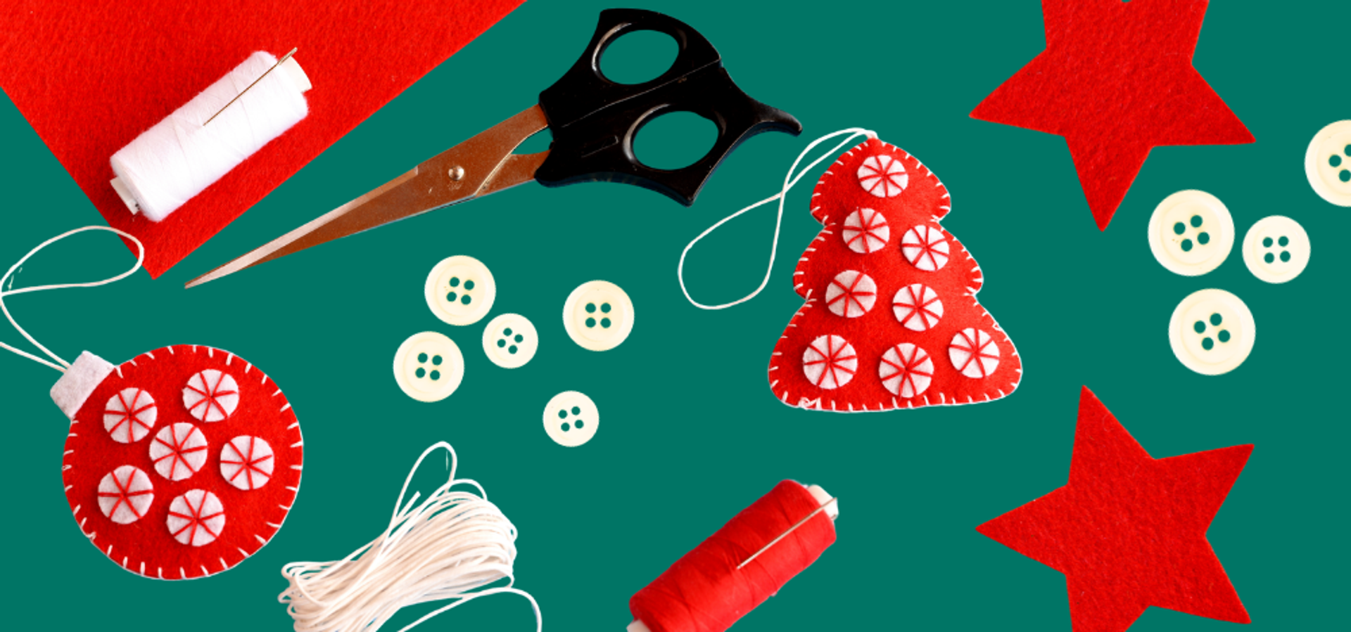 felt tree and bauble shaped ornaments with thread, buttons and scissors surrounding