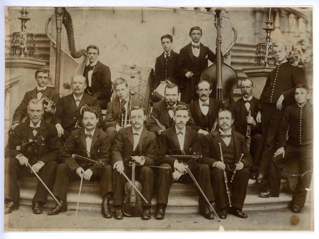 Dearlove band, a group of 16 men in suits and bow ties with orchestral instruments