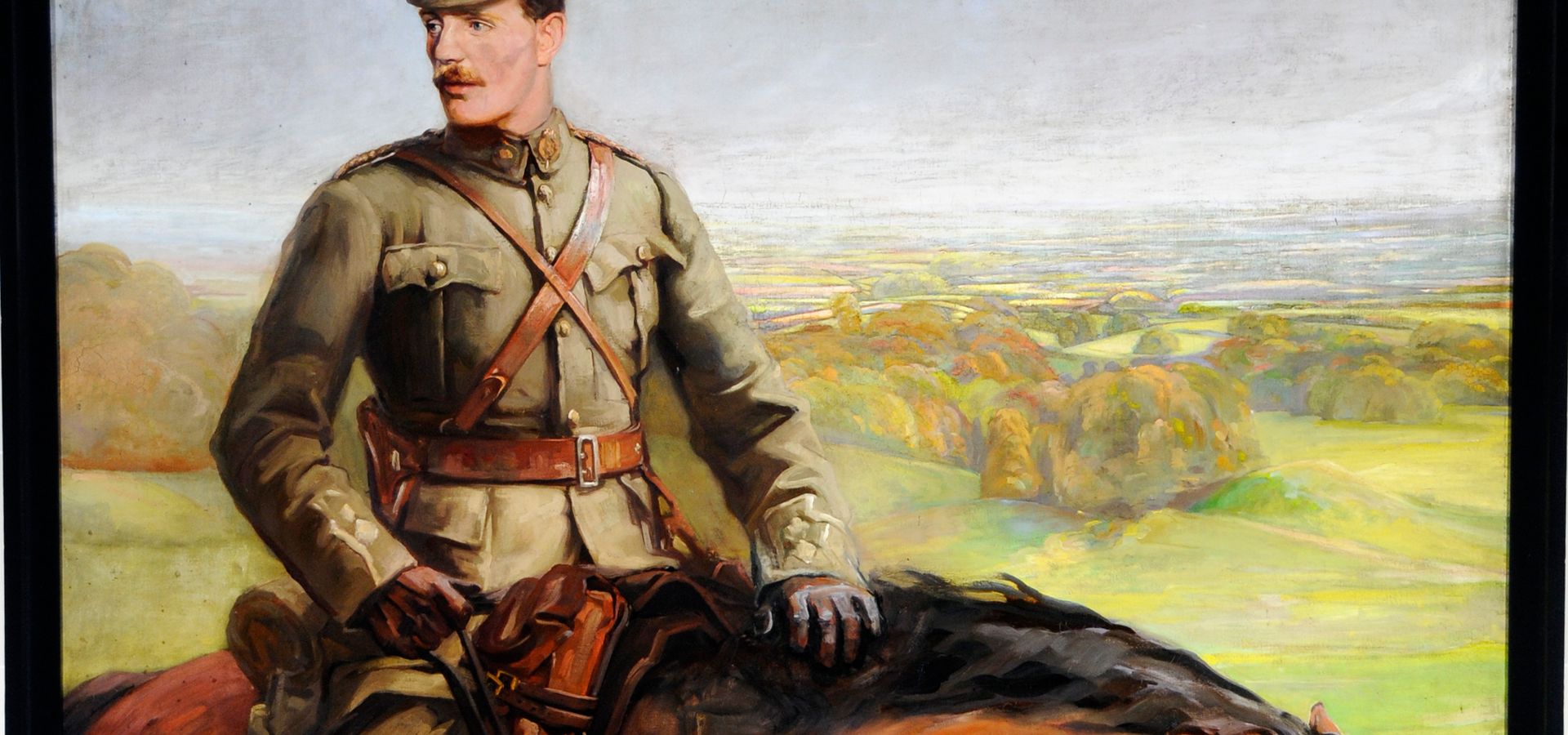 A portrait of a man in a military outfit on a horse