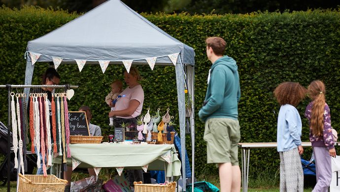 Family at an artisan fair looking at a craft stall