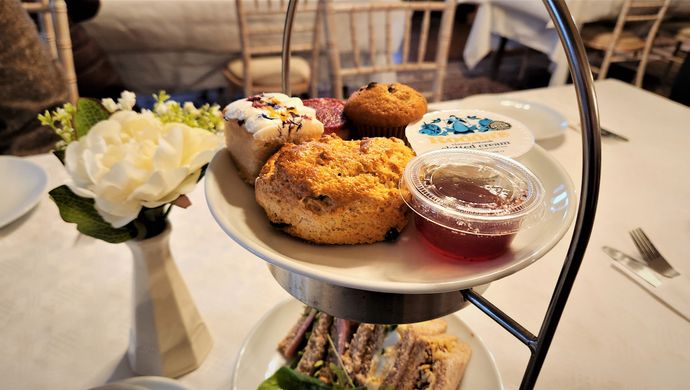 Afternoon tea with scones, cake and sandwiches