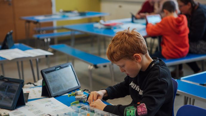 A boy doing crafts at a table