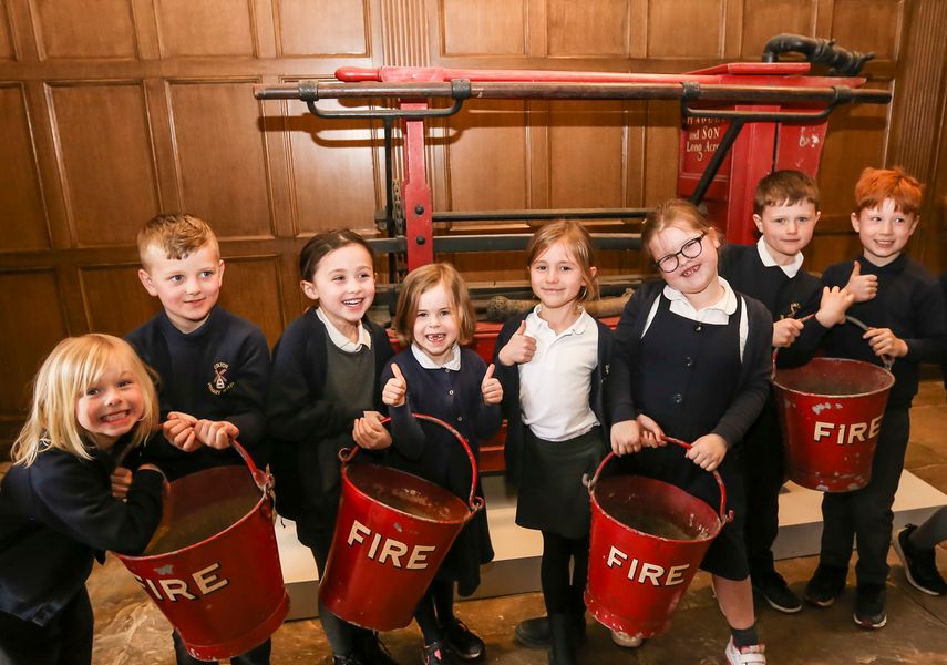 Image of school children holding fire buckets