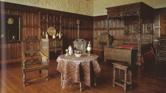 Historic Bretton Room at Temple Newsam featuring dark wood panelled walls, an elaborate carved bed, and antique furnishings