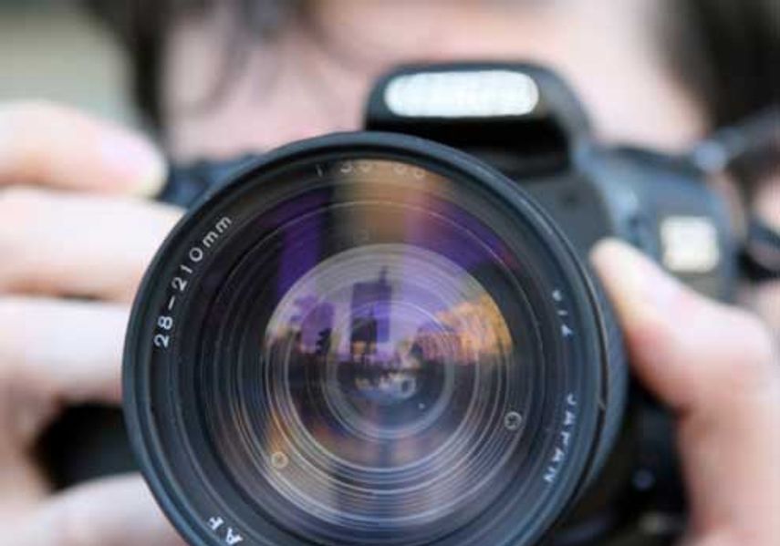 A man uses a professional camera. 