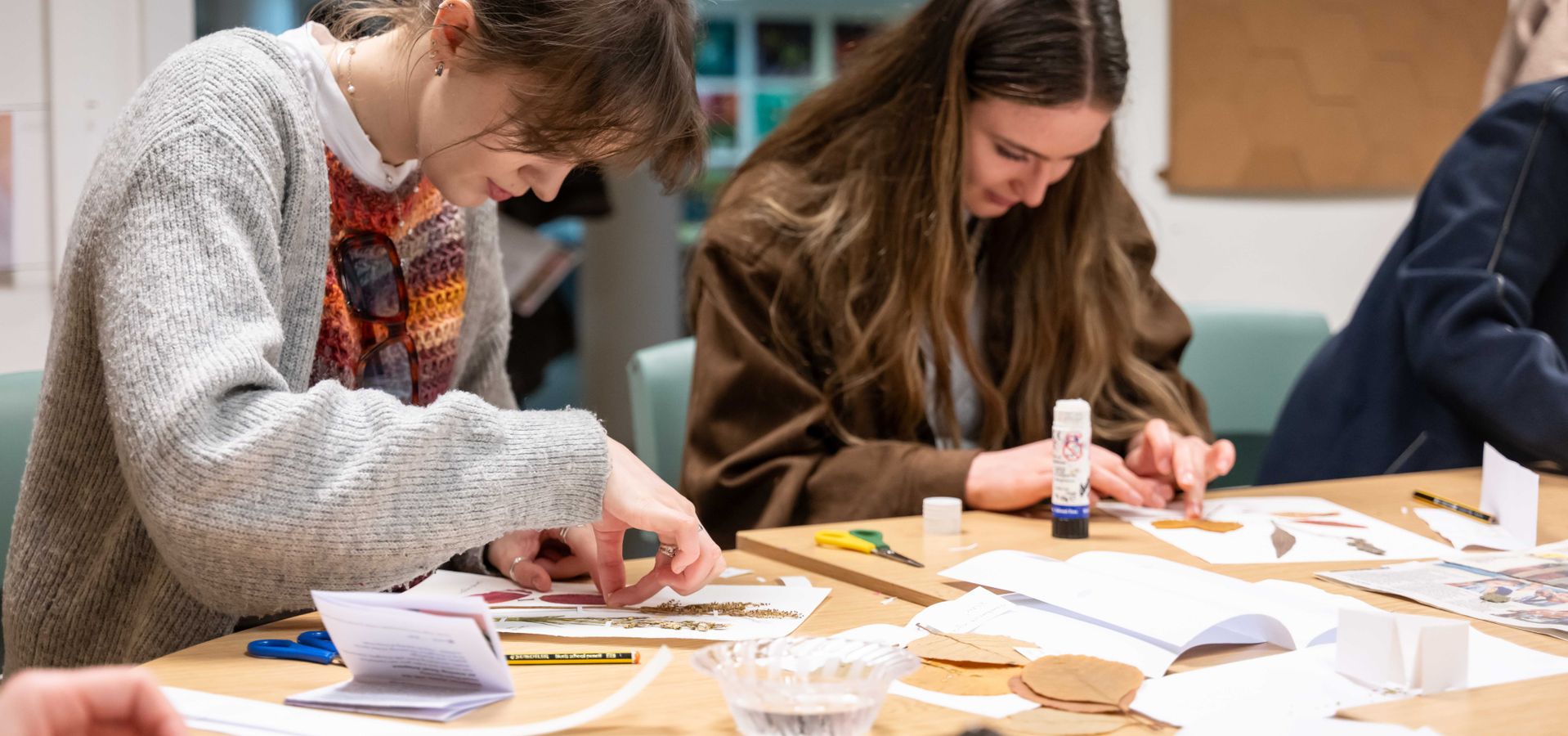 two people doing plant crafts at a table