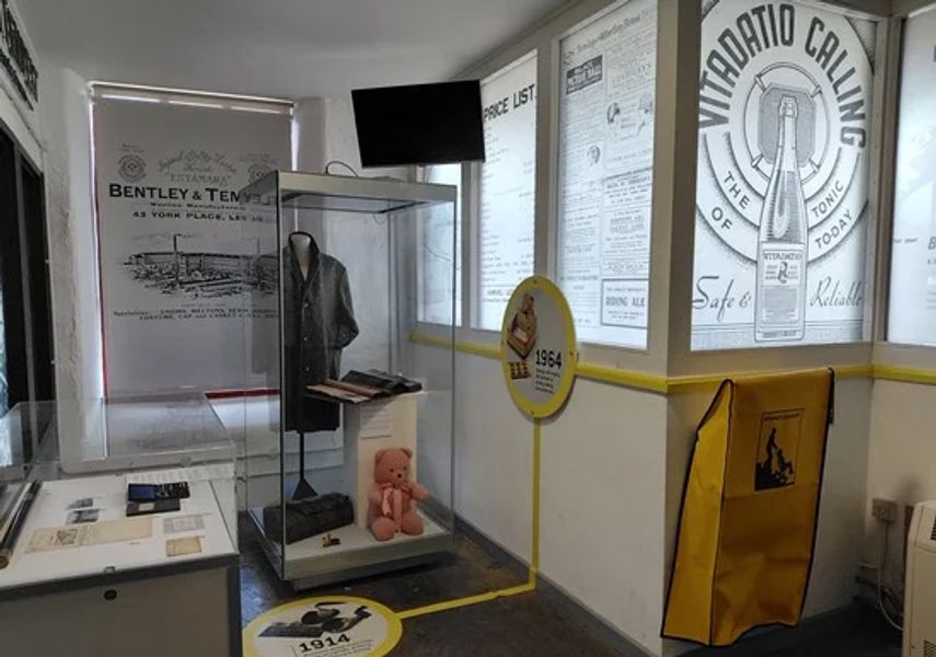 Photo of inside museum with class cabinet display of a jacket