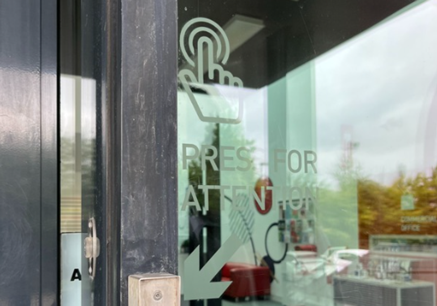 A doorbell button on the right-hand side of the entrance door