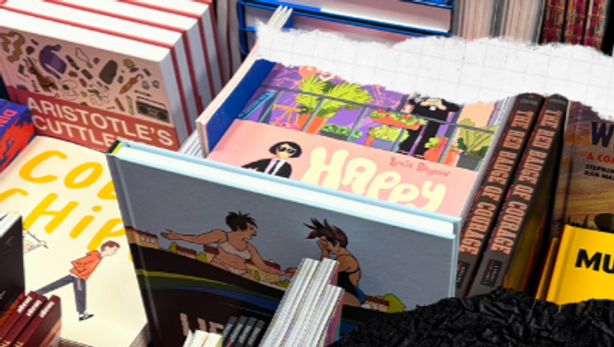 piles of hard back comics